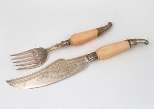 A pair of antique English silver plated fish servers with engraved decoration and ivory handles, 19th century, the larger 33cm long.