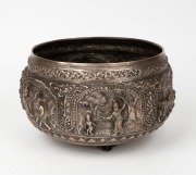 A vintage Burmese silver plate on copper bowl with ornate repousse decoration, 20th century, 15cm high, 24cm wide.