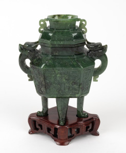 A Chinese carved spinach jade lidded vessel on carved timber stand, 20th century, 17cm high overall.