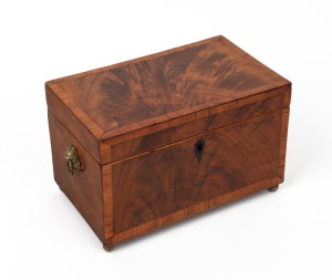 An antique English flame mahogany tea caddy, cross banded in kingwood with ebony escutcheon plus brass handles and feet, interior fitted with two lidded compartments with turned ivory knobs, early 19th century, 14cm high, 22cm wide, 13cm deep.