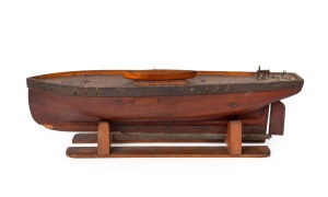 A vintage pond yacht hull on timber stand, early to mid 20th century, ​​​​​​​62cm long.