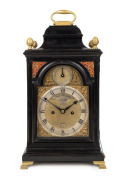A Georgian spring table clock in ebonized bell-top case with break arch dial, strike silent subsidiary, recessed maker's plate "PAUL RIMBAULT, LONDON", date aperture above the "6" and silver chapter ring with Roman numerals and Arabic minute track. Fusee 