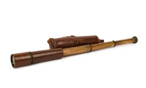 An attractive antique brass telescope and leather covered three draw with broad arrow marks in original case, 81cm long when open.