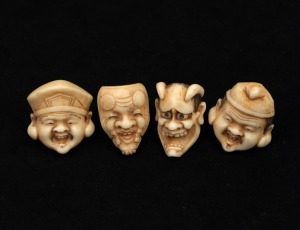 Four Japanese carved ivory kabuki face mask toggles, Meiji period, 20th century, each approximately 3.5cm high.