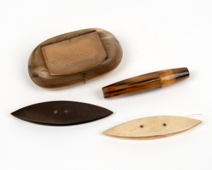 A Georgian carved horn pocket snuff box, together with two sewing thread shuttles made from whale bone and baleen, as well as a turned horn needle case, 19th century, (4 items), ​​​​​​​the box 7.5cm wide.
