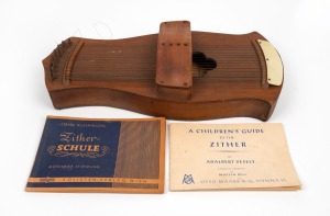 An antique zither; together with two zither music books, early 20th century, (3 items), 52cm long.