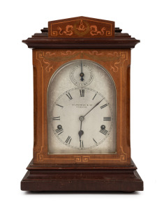 An antique mantle clock in an English mahogany case with marquetry inlay, three train German movement with gong rod striking on the quarters and the hour, circa 1900, retailed by KILPATRICK & Co. of Melbourne. 42cm high.