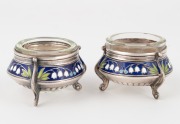 A pair of Eastern European silver salt cellars decorated with lily of the valley in enamel, with glass liners, 20th century, 3.5cm high, 5.5cm wide, 70 grams total (not including liners). - 2