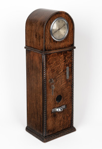 A vintage English oak cased one penny confectionery vending machine, the arch top fitted with later eight day time only movement, ​​​​​​​55cm high.