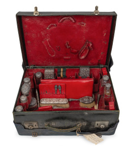 Antique leather travelling case fitted with an assortment of sterling silver topped accessories, boxes, jars, brushes etc., many manufactured by Asprey of London, early 20th century, the case 52cm wide.