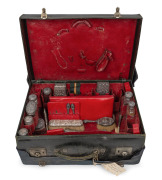 Antique leather travelling case fitted with an assortment of sterling silver topped accessories, boxes, jars, brushes etc., many manufactured by Asprey of London, early 20th century, the case 52cm wide.