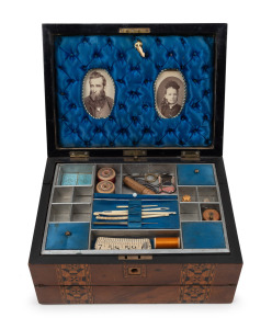 An antique English walnut sewing box lap desk with Tunbridge style banding. Interior handsomely fitted with compartments in original blue silk housing antique portrait photographs, 19th century, 17cm high, 31cm wide, 23cm deep.