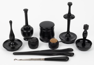 A handsome selection of antique ebony sewing and vanity implements, including sterling silver mounted glove stretcher, lace hook and bog oak Irish pin cushion, 19th century, (8 items), the glove stretcher 20cm long.