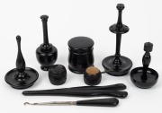 A handsome selection of antique ebony sewing and vanity implements, including sterling silver mounted glove stretcher, lace hook and bog oak Irish pin cushion, 19th century, (8 items), the glove stretcher 20cm long.