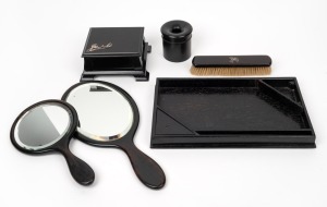 Assorted antique English ebony vanity ware comprising of mirror, brush, tray, box and canister, 19th century, (6 items), the tray 29cm wide.