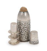 An antique sterling silver pocket sewing accessory with engraved decoration and pin cushion top, compartment base housing a sterling silver double spool needle case with sterling silver thimble, 19th/20th century, stamped "STERLING" inside the lid, 6cm hi