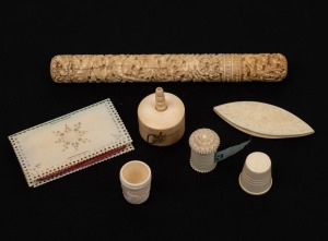 Antique Chinese carved ivory needle case; together with an antique carved ivory and tortoiseshell tape measure, an antique carved ivory needle book, two thimbles, a Chinese carved ivory tape measure and an antique carved ivory thread shuttle, 19th century, (7 items), the needle case 16cm high.