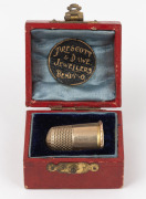 An antique 9ct gold thimble with engraved ownership monogram, housed in an attractive fitted case with "PRESCOTT & DAWE JEWELLERS, BENDIGO" branding, 19th century, 4 grams. - 2