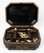 An antique Chinese export ware lacquered sewing box with chinoiserie decoration, interior fitted with compartments and housing a selection of bone and ivory implements, 19th century, 14cm high, 33cm wide, 24cm deep.