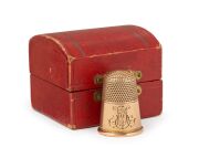 An antique 9ct gold thimble with engraved ownership monogram, housed in an attractive fitted case with "PRESCOTT & DAWE JEWELLERS, BENDIGO" branding, 19th century, 4 grams.