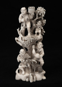 A Japanese carved ivory figural group, early to mid 20th century, seal mark to base, 12.5cm high.