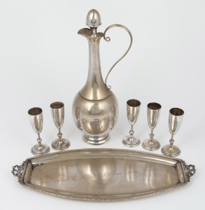 A Continental silver schnapps ewer with engraved floral decoration together with a matching tray and five goblets, circa 1900, (7 items), the ewer 25cm high, 620 grams total.