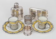 An English full sterling silver hipflask; together with a cigarette case with inscription "From the Durban Hebrew Congregation as a Token of Esteem, 1920" and three pierced sterling silver demi-tasse cup holders (with two porcelain cups and saucers) plus 