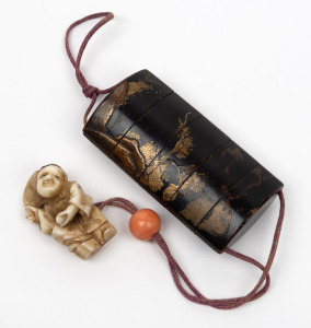 An antique Japanese black lacquered inro with coral ojime and carved ivory netsuke, Meiji period, 19th century, the inro 7.5cm high.
