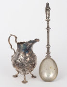 An antique English sterling silver cream jug with floral repousse decoration; together with a sterling silver apostle spoon (unknown age), (2 items), ​​​​​​​the jug 11.5cm high, 174 grams total.