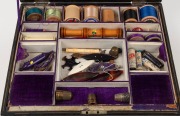 An antique English papier-m&acirc;ch&eacute; sewing workbox fitted with lift-out tray and compartments adorned with original purple velvet and silk, also includes a selection of threads, thimbles, shuttles and sewing accessories, 19th century, 14cm high, 28cm wide, 25 - 2