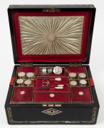 An antique sewing work box with ebonized finish and shell inlaid decoration. Interior handsomely fitted in scarlet and cream silk with compartments and an assortment of mother of pearl sewing implements, 19th century, 13cm high, 30cm wide, 23cm deep.