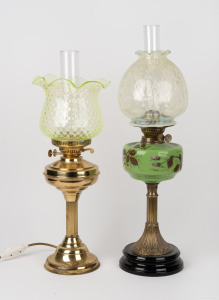 An antique oil lamp with lemon vaseline glass shade, hand-painted green glass font, double burner and brass column, 19th century, together with a brass electric lamp with uranium glass shade, (2 items), ​​​​​​​58 x 52cm high.