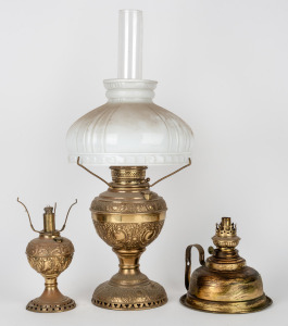 Three antique brass oil lamps, including an example with milk glass shade and chimney, 19th/20th century, the largest 57cm high.