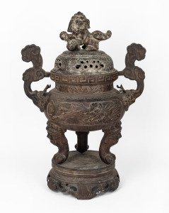 A Chinese cast metal censer with foo dog finial, cloud handles and separate base, 20th century, 66cm high overall.