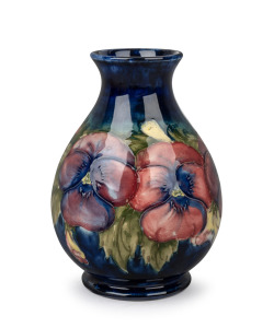 MOORCROFT "Pansy" pattern English pottery vase on blue ground, impressed signature mark and original paper label to base "By Appointment W. Moorcroft, Potters To H.M. Queen Mary", 15.5cm high.