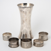 An English sterling silver vase, together with five assorted sterling silver napkin rings, 19th/20th century, (6 items), the vase 15cm high, 300 grams total.