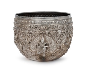 An antique Burmese silver bowl with repousse vignettes and floral decoration, 19th/20th century, 11cm high, 15cm wide, 442 grams.