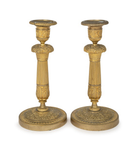 A pair of French Empire ornate gilt bronze candlesticks, 19th century, ​​​​​​​20cm high.