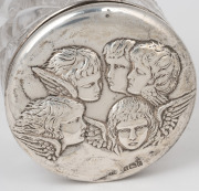 A sterling silver wine bottle coaster; together with an antique Chorus of Angels sterling silver topped vanity jar, 19th century, (2 items), the coaster 6cm high, 15cm diameter. - 2