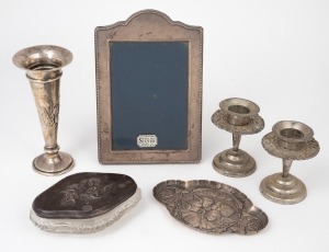 A vintage sterling silver picture frame, a sterling silver trumpet vase with repousse iris decoration (weighted base), a pair of Continental silver candle holders (weighted bases), "Chorus of Angels" sterling silver dish and lidded crystal box, 19th/20th century, (6 items), the frame 17cm high.