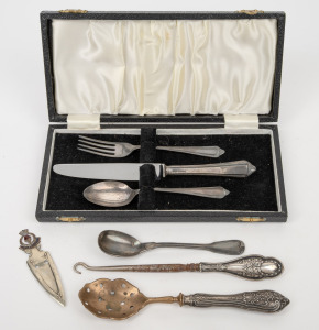Sterling silver handled lace hook, sifting spoon and a three piece boxed cutlery place setting, together with a silver plated mustard spoon and bookmark, 19th/20th century, (7 items), the hook 17cm long.