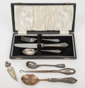 Sterling silver handled lace hook, sifting spoon and a three piece boxed cutlery place setting, together with a silver plated mustard spoon and bookmark, 19th/20th century, (7 items), the hook 17cm long.