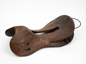 An antique wooden saddle from Flores, Indonesia, 37cm long.