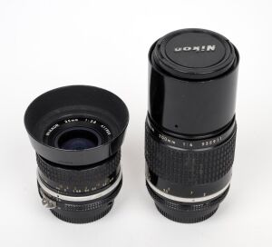 NIPPON KOGAKU: Group of two Nikon lenses - one Nikkor 35mm f2.8 with rear cap and HN-3 lens hood, together with one Nikkor 200mm f4 (front and rear caps present).