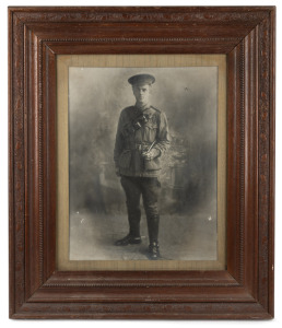 A framed photograph portrait of an Australian WWI soldier, pencil inscription verso dated 1917, 70 x 60cm overall.