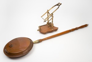 A reproduction copper bed warmer with timber handle; together with a reproduction brandy bottle warmer, late 20th century, (2 items), the bed warmer 105cm long.