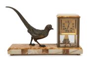 A French Art Deco mantle clock with spelter pheasant decoration on an onyx and marble base, circa 1925, 28cm high, 50cm wide.