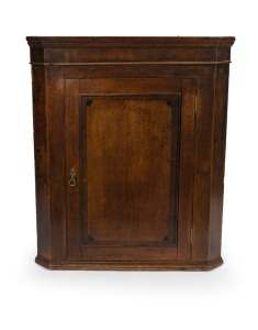 A Georgian oak wall mounted corner cabinet, 18th/19th century, ​​​​​​​with yellow painted interior, 104cm high, 88cm wide, 46cm deep.