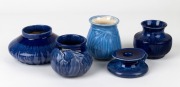 MELROSE WARE four assorted blue glazed pottery vases (two with gum leaf decoration); together with a rare candle holder, (5 items), the largest 10.5cm high