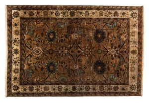 A hand-knotted Indian woollen rug on caramel ground, retailed by Hali Rug Galleries of Melbourne, 273 x 187cm.